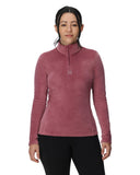 Woman wearing a pink long-sleeve shirt with a brand logo on a white background