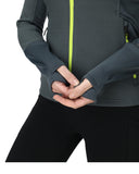 Person wearing a gray jacket with a green zipper, holding hands together.