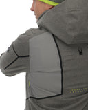 Person wearing a gray jacket with a brand logo on a white background