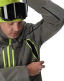 Person wearing a gray jacket with green accents and a helmet, on a white background