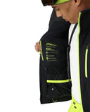 Person wearing a black and yellow jacket with Spyder branding on a white background