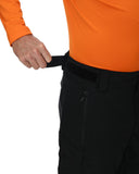Person wearing black pants with an orange shirt on a white background