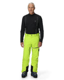 Person wearing a black top and bright green pants on a white background