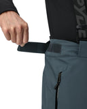 Person adjusting a black strap on a black jacket with a visible brand logo.