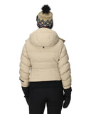 Person wearing a beige puffer jacket, black pants, and a patterned beanie on a white background