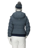 Person wearing a blue puffer jacket and white pants on a white background