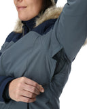 Close-up of a person wearing a gray winter jacket with fur-lined hood.